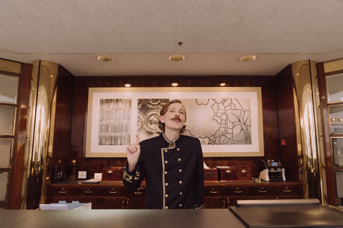 Concierge en uniforme derrière le comptoir d’un hôtel